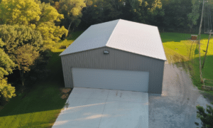 Aerial view of a large steel garage in Alberta surrounded by vast scenic landscape and greenery