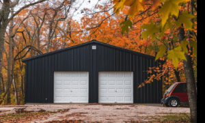 Black metal garage with white double doors located in Alberta on a sunny day featuring modern design and sturdy construction.